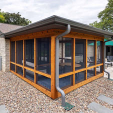 We transformed the aging porch on this house into a beautiful and modern jewel box porch full of comfort and function.