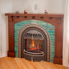 Custom-designed tile and woodwork surround this cozy fireplace.