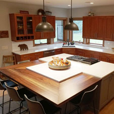 This kitchen's large island makes for an eye-catching centerpiece, functioning as a place for gathering, entertaining, and cooking.