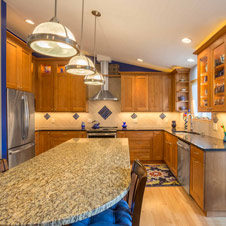 This kitchen remodel balances warmth with the coolness of vibrant accent blues.
