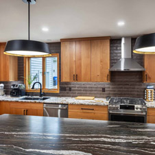The layout for this kitchen was completely updated with new locations for the stove and refrigerator, a new island, and expanded storage with beautiful cherry cabinets.