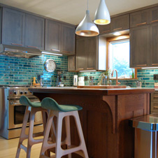 Cool teals, turquoises, and grays lend a calming presence to this kitchen.