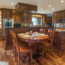 This kitchen remodel combines medium wood tones with grays and golds for a warm, welcoming feel.